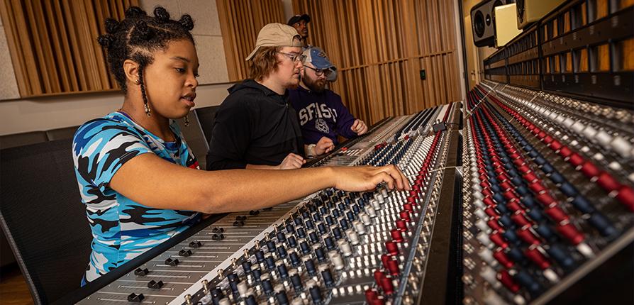 Students recording sound in the studio