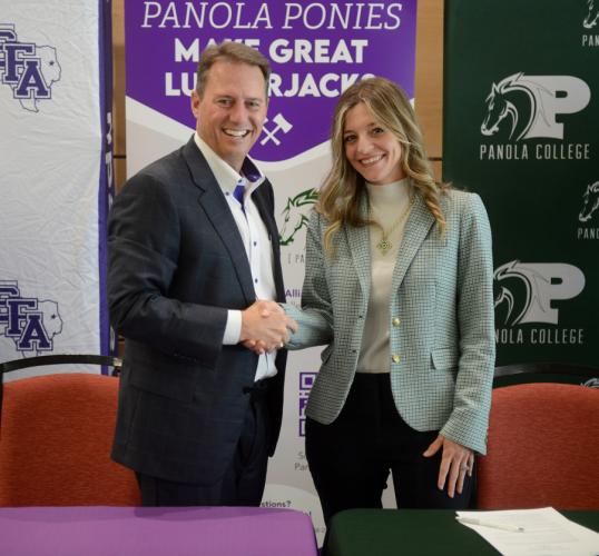 Dr. Neal Weaver, Stephen F. Austin State University president, and Dr. Jessica Pace, Panola College president, shake hands after signing the Lumberjack Transfer Alliance agreement during SFA Day at Panola College April 21.