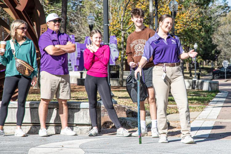 A Jack Walker leads a campus tour for students and their families at SFA