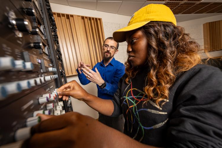Dr. James Adams working with a sound recording technology student