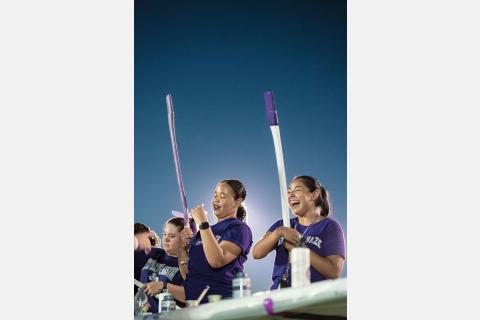 students decorating axe handles