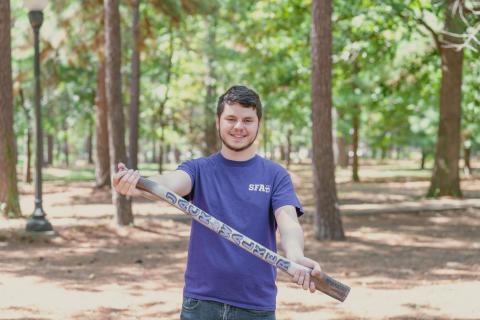 student holding axe handle