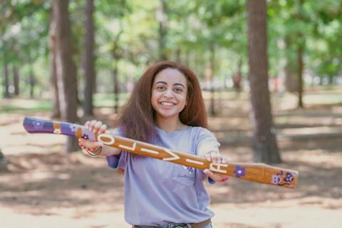 student holding axe handle