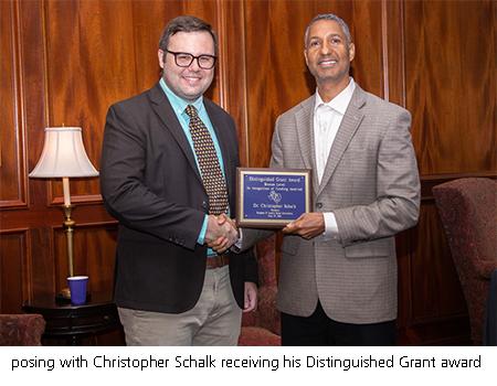 posing with Christopher Schalk receiving his Distinguished Grant award