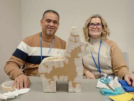 Parents Jose, left, and Inmaculada Escobedo attend a workshop that included creating their very own piñata. 