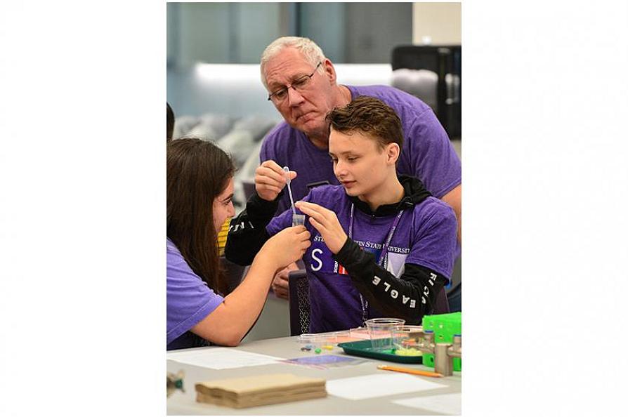Dr. Dennis Gravatt with two STEM Day students