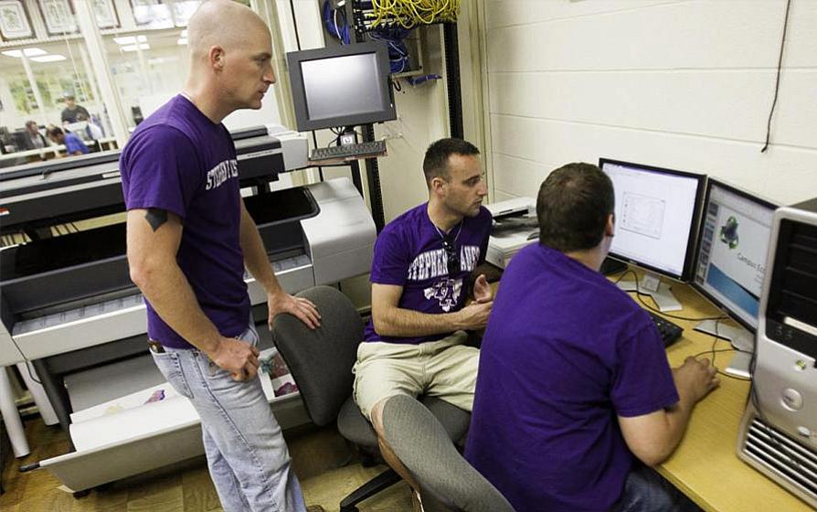 students looking at computer monitors