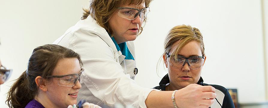 lab instructor working with students