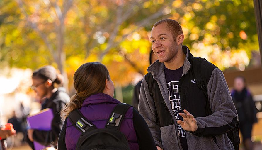 guy and girl talking on an autumn day