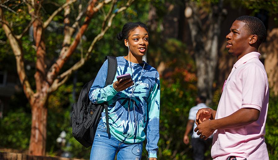 girl with ipods talking to guy
