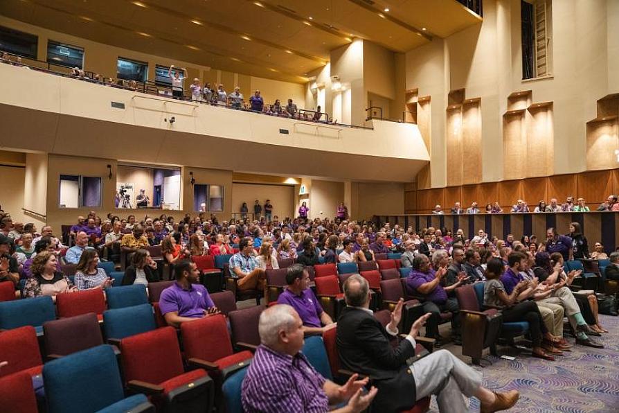 Audience seated in a large auditorium during a back-to-fall presentation