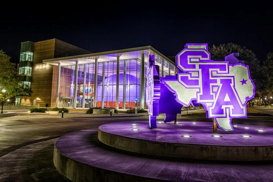 Illuminated STEM building and SFA sign at night