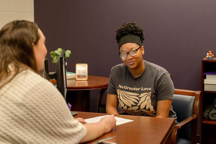 Student talking with an advisor in an office setting