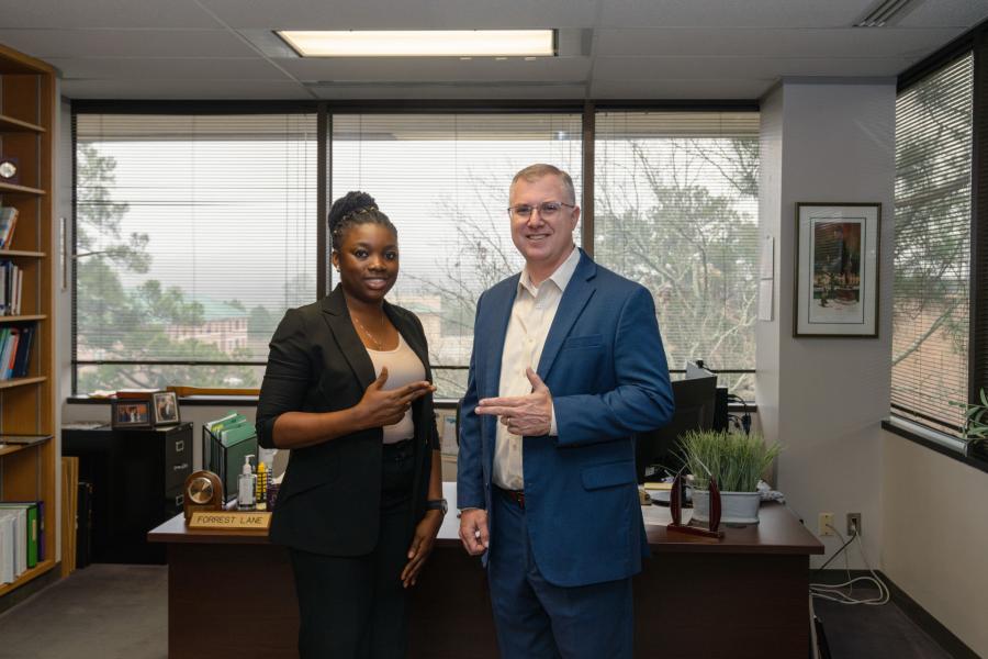 3MT® Competition winner Angela Nkeiruka Aziekwu and Dr. Forrest Lane, dean of the Office of Research and Graduate Studies